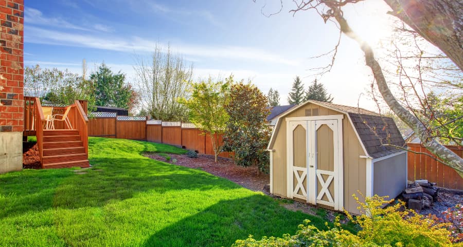 Fenced backyard with storage shed in Orange County